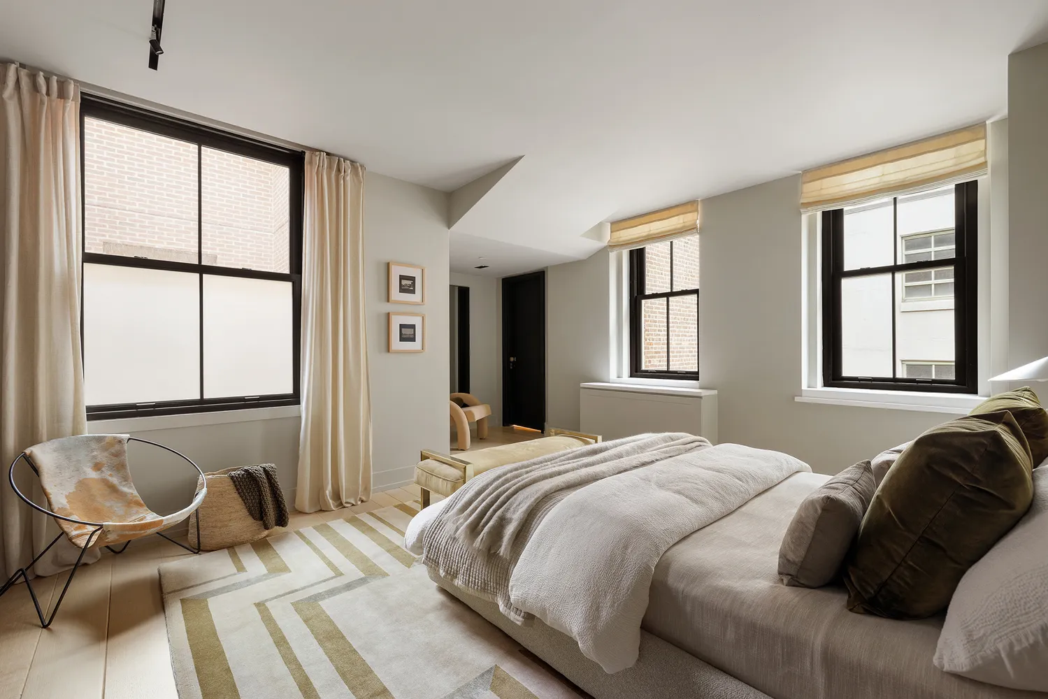 a bedroom with a bed and windows