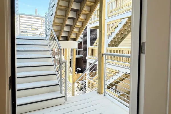 a view of entryway with a window and wooden floor