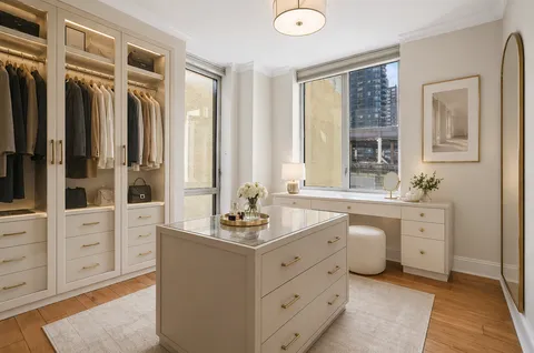 a bathroom with a double vanity sink a mirror and a bathtub