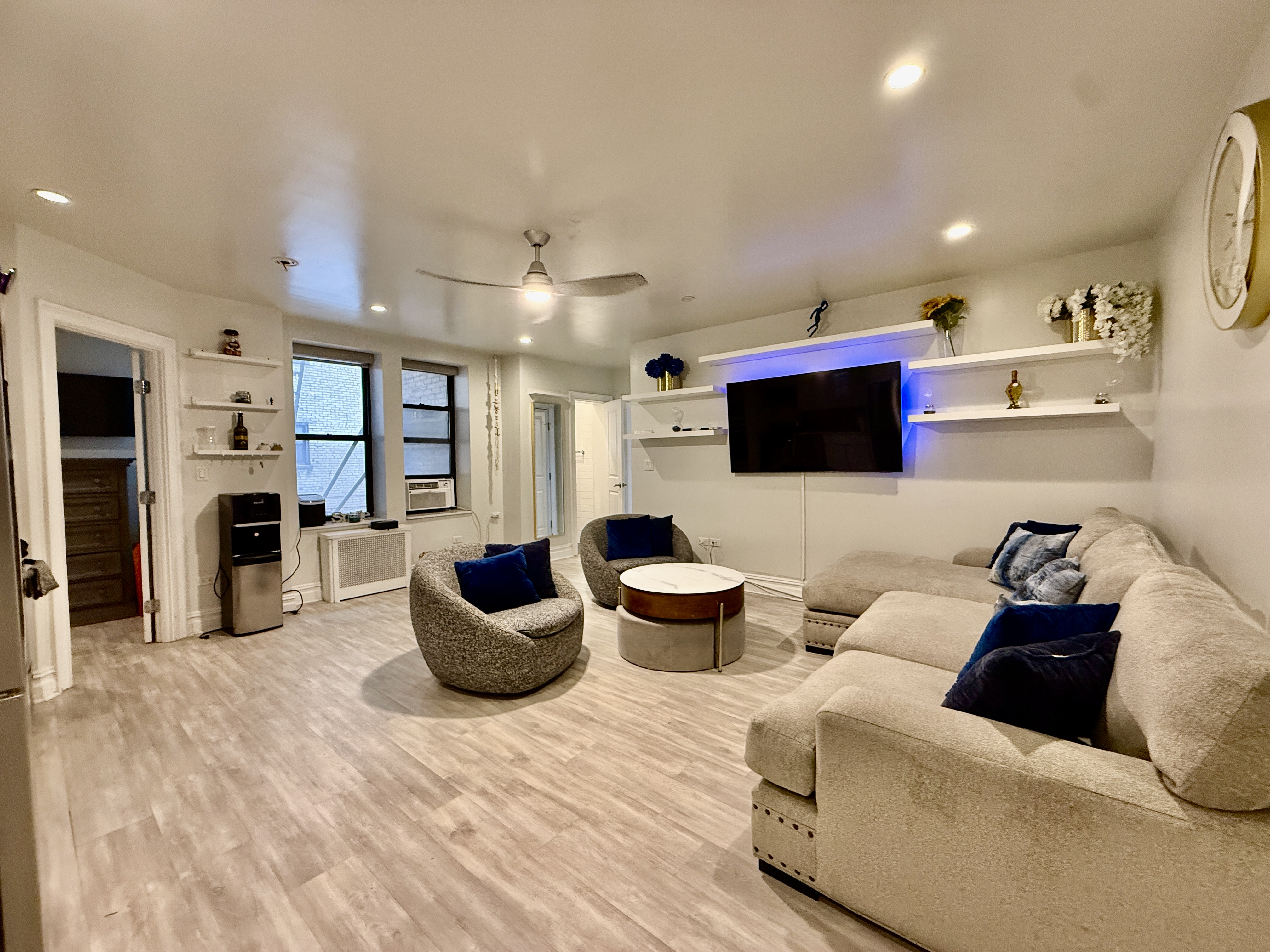 a living room with furniture and a flat screen tv