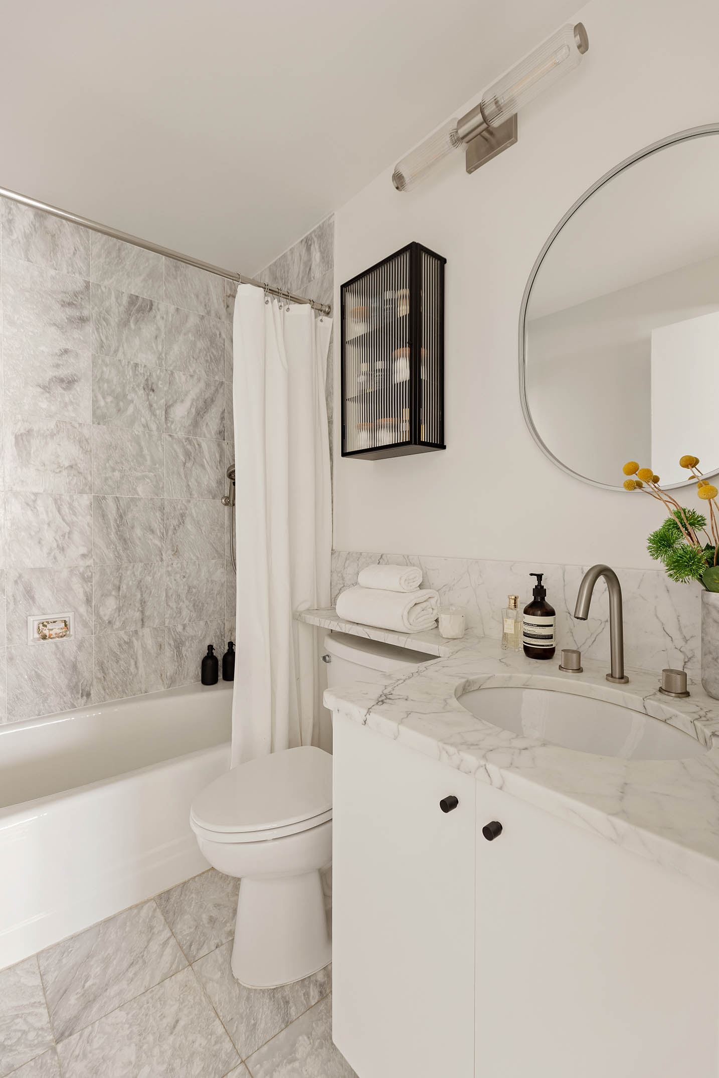295 Greenwich Street, Unit 8/9H Manhattan, NY 10007 - Photo 11 of 22 a bathroom with a sink toilet and shower