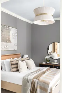 a bedroom with bed and a chandelier