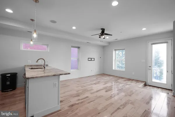 a view of a kitchen with a sink stainless steel appliances and cabinets