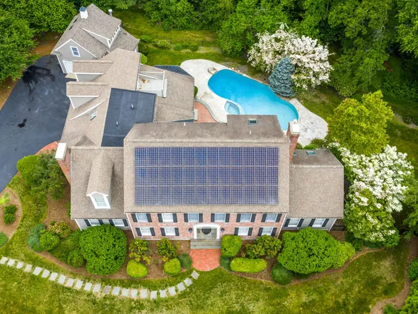 a view of a house with a yard and potted plants