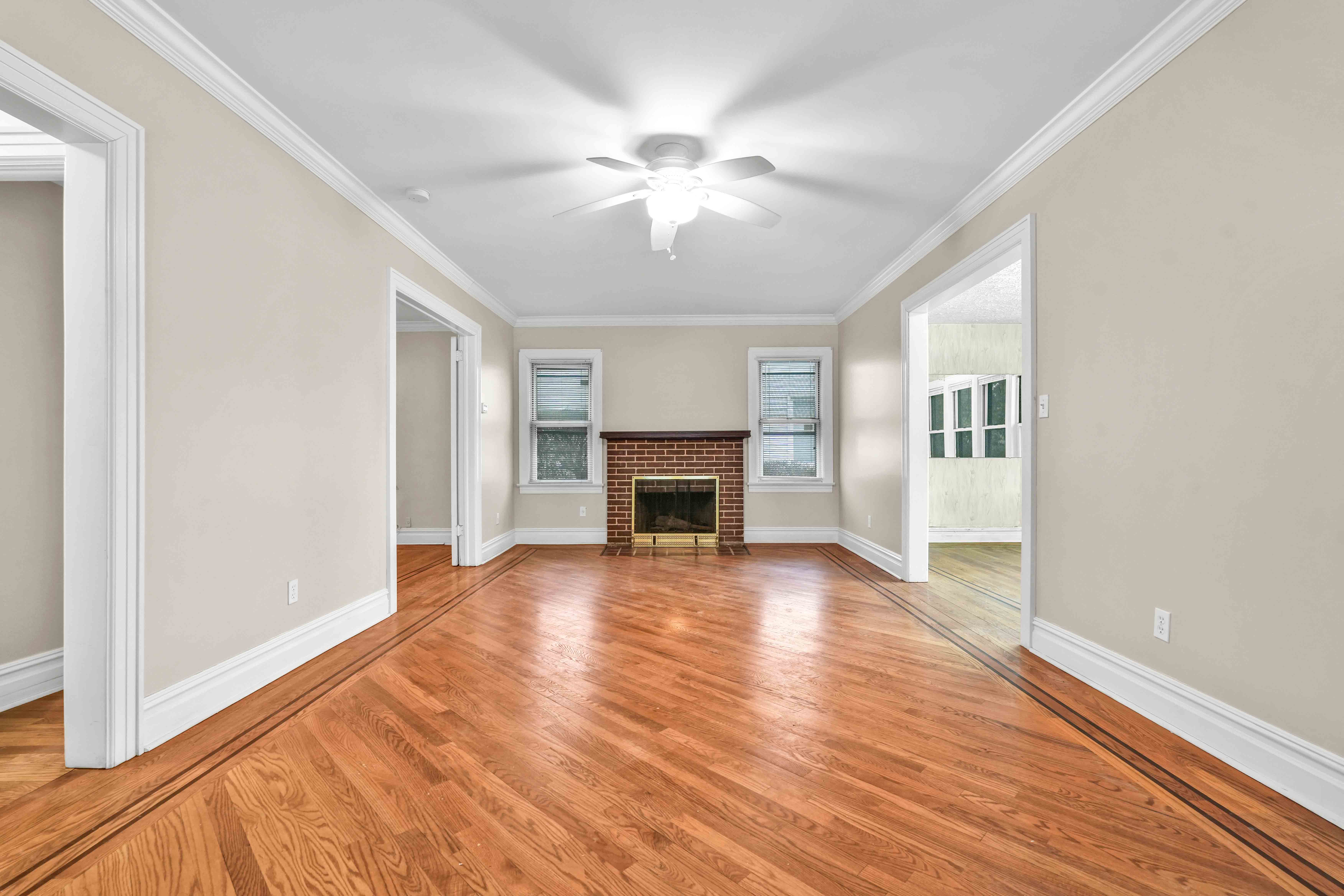 188-22 Lewiston Avenue, Unit 1 Queens, NY 11412 - Photo 4 of 17 a view of a livingroom with wooden floor and a fireplace