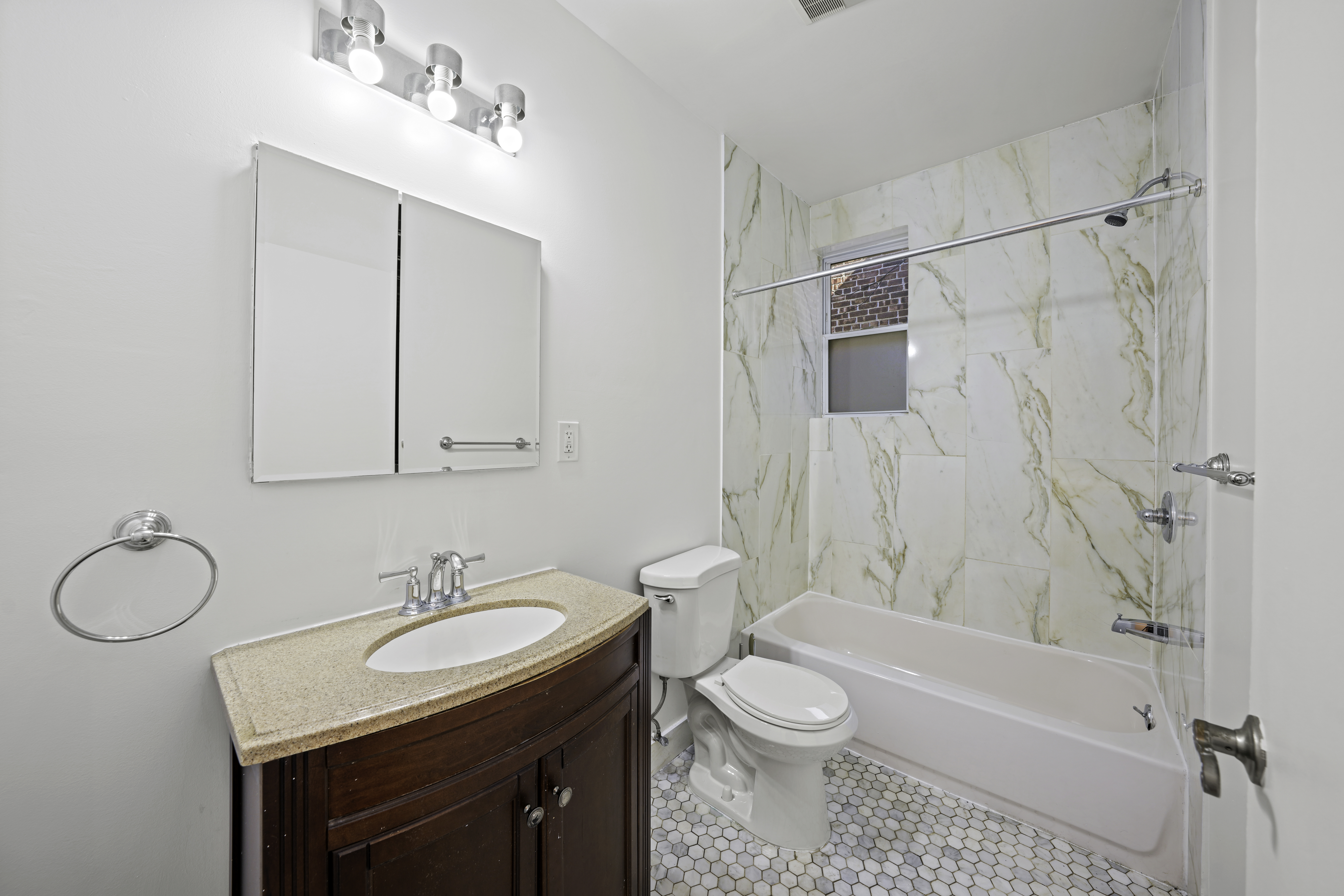514 86th Street, Unit 4 Brooklyn, NY 11209 - Photo 18 of 19 a bathroom with a granite countertop sink toilet and shower