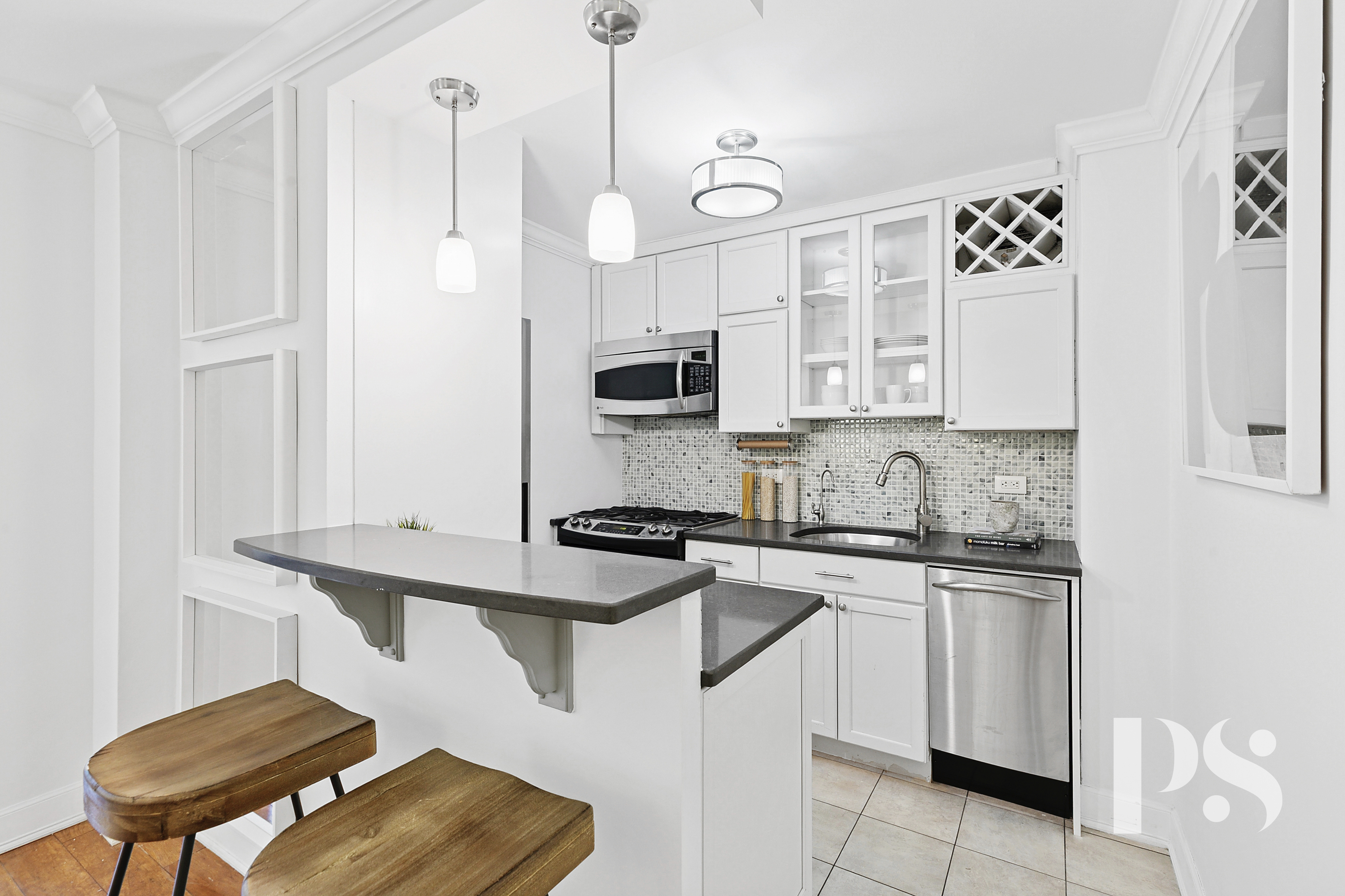 333 East 79th Street, Unit 6R Manhattan, NY 10075 - Photo 4 of 8 a kitchen with stainless steel appliances granite countertop a stove a sink and a refrigerator