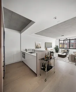a bedroom with a bed and a flat tv screen on dresser