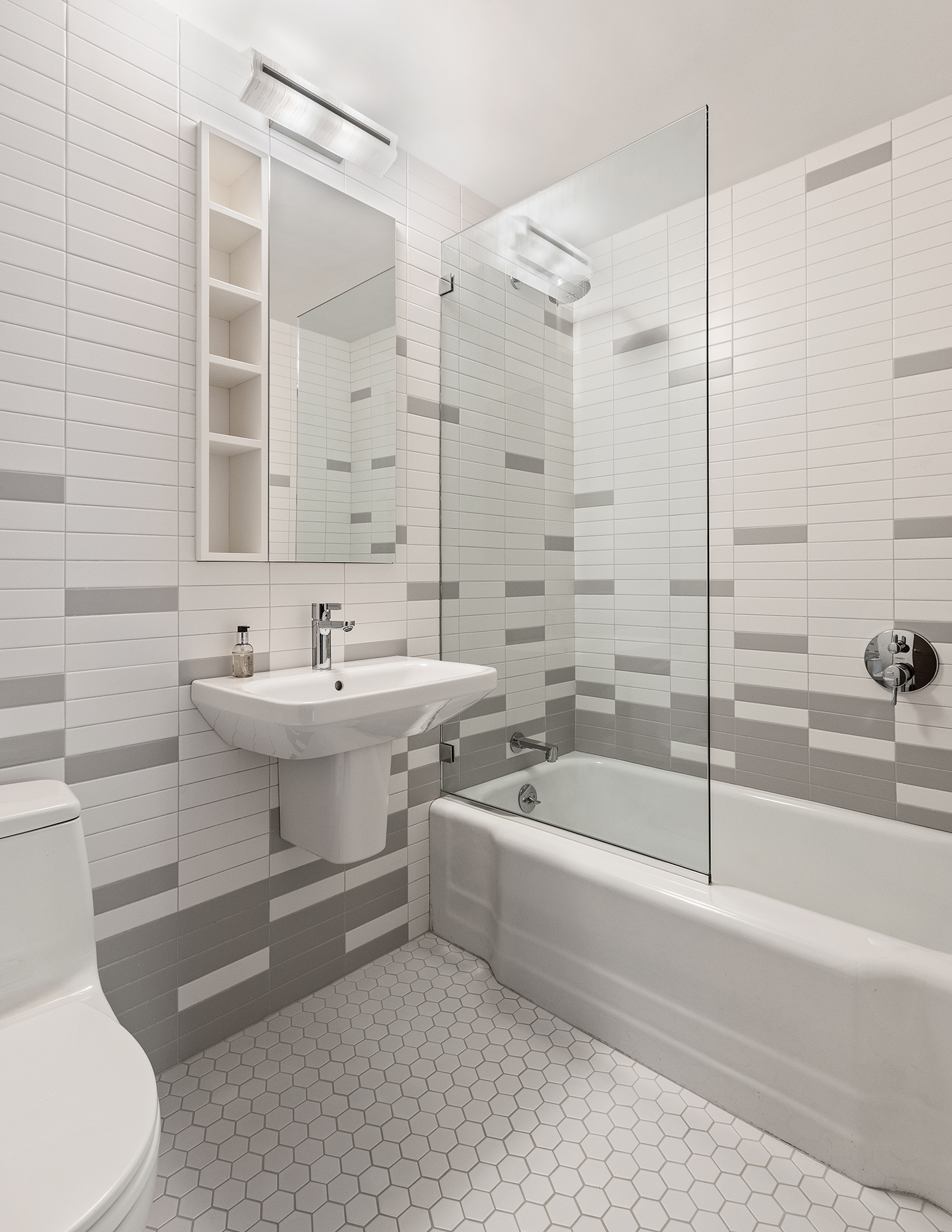 37 West 12th Street, Unit 7J Manhattan, NY 10011 - Photo 13 of 18 a bathroom with a sink a toilet and shower