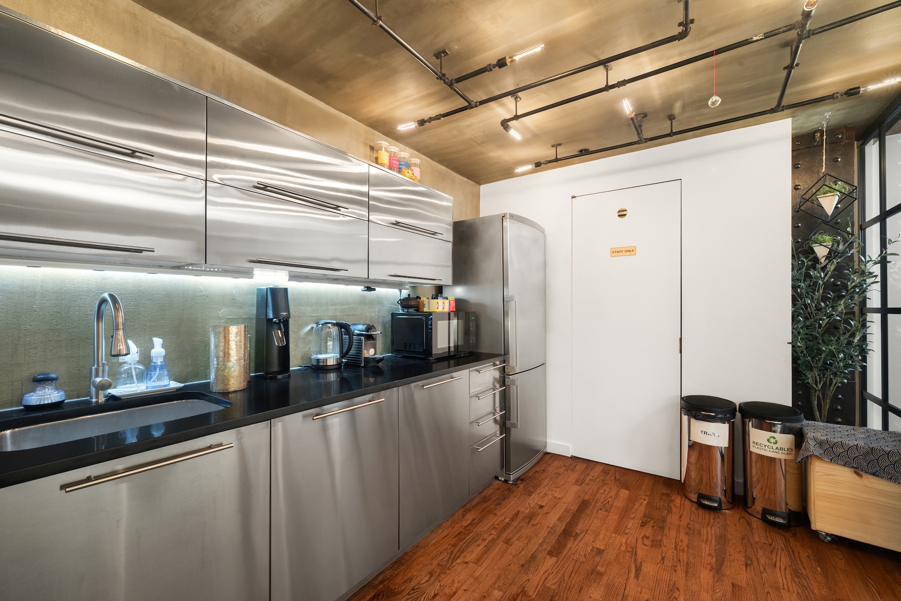 14 East 4th Street, Unit 604 Manhattan, NY 10012 - Photo 5 of 14 a kitchen with stainless steel appliances granite countertop a refrigerator a sink and wooden floors