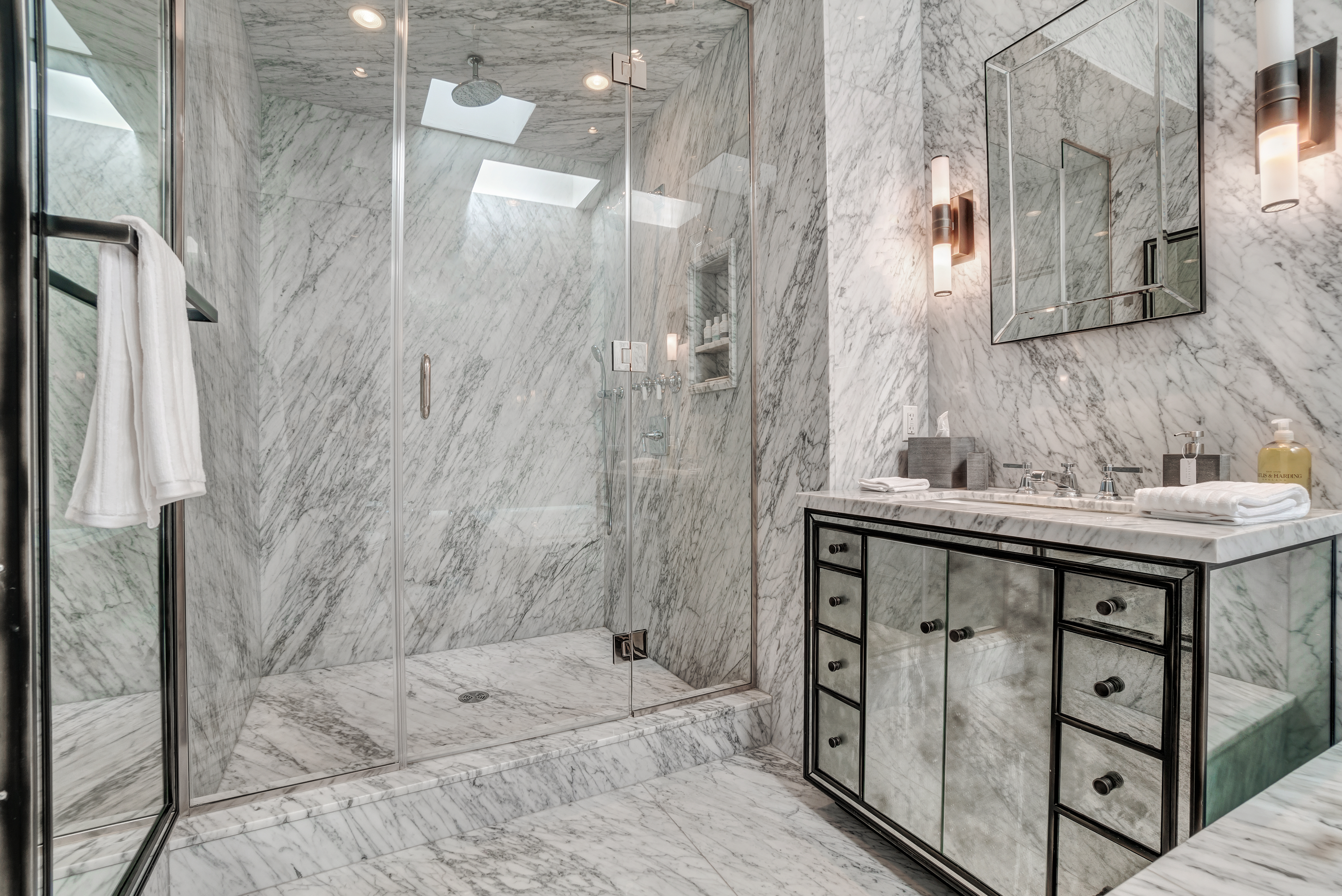 145 Spring Street, Unit PH Manhattan, NY 10012 - Photo 5 of 11 a bathroom with a sink mirror and a shower