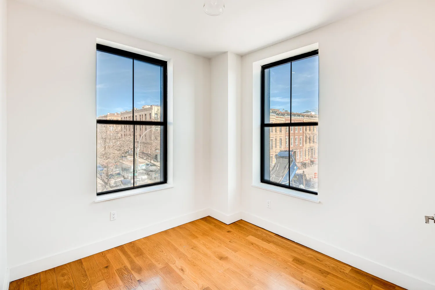 a view of an empty room with windows and closet