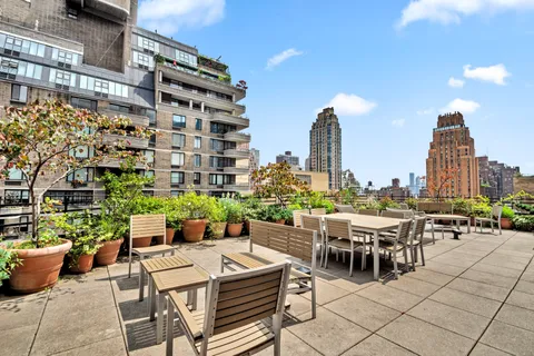 a view of a patio with a table and chairs and potted plants
