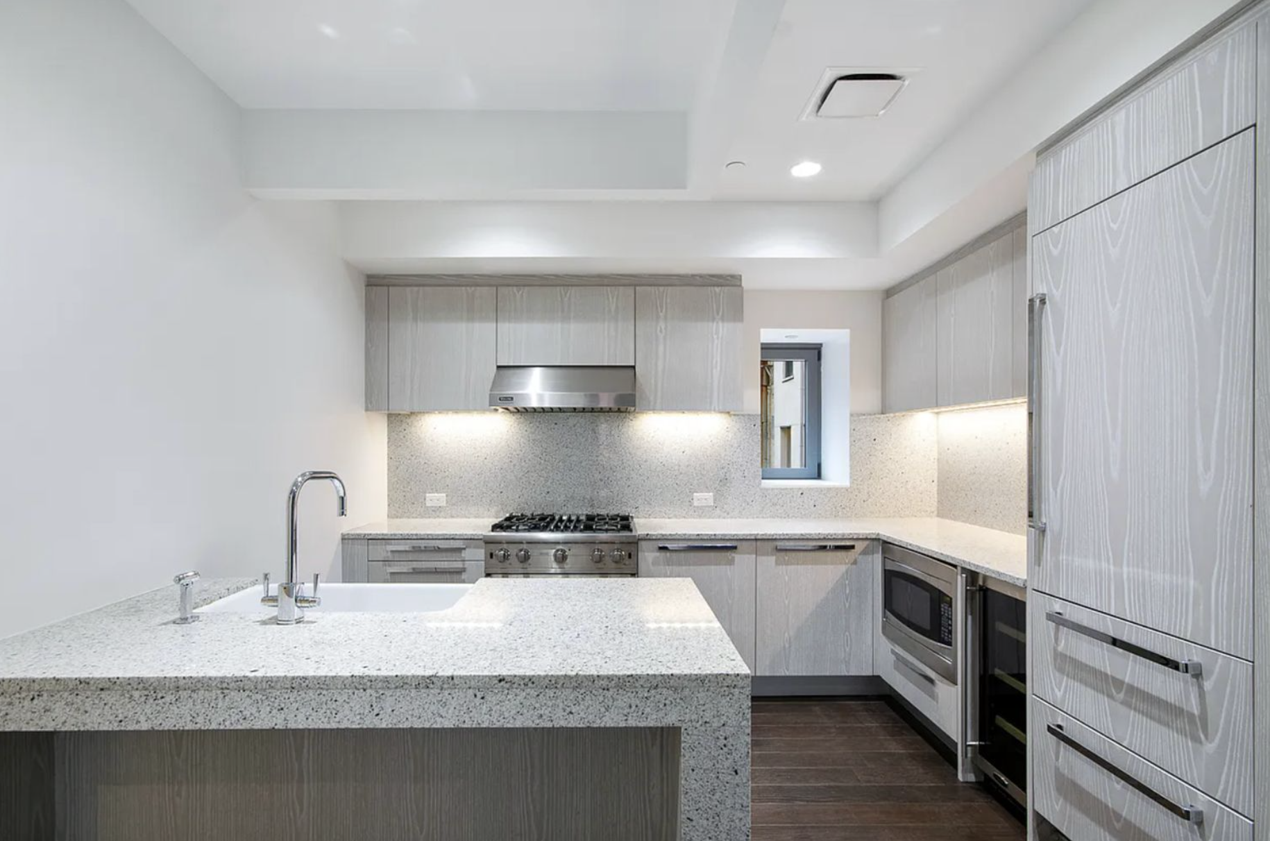 37 Warren Street, Unit 3C Manhattan, NY 10007 - Photo 4 of 16 a kitchen with stainless steel appliances a sink stove and refrigerator