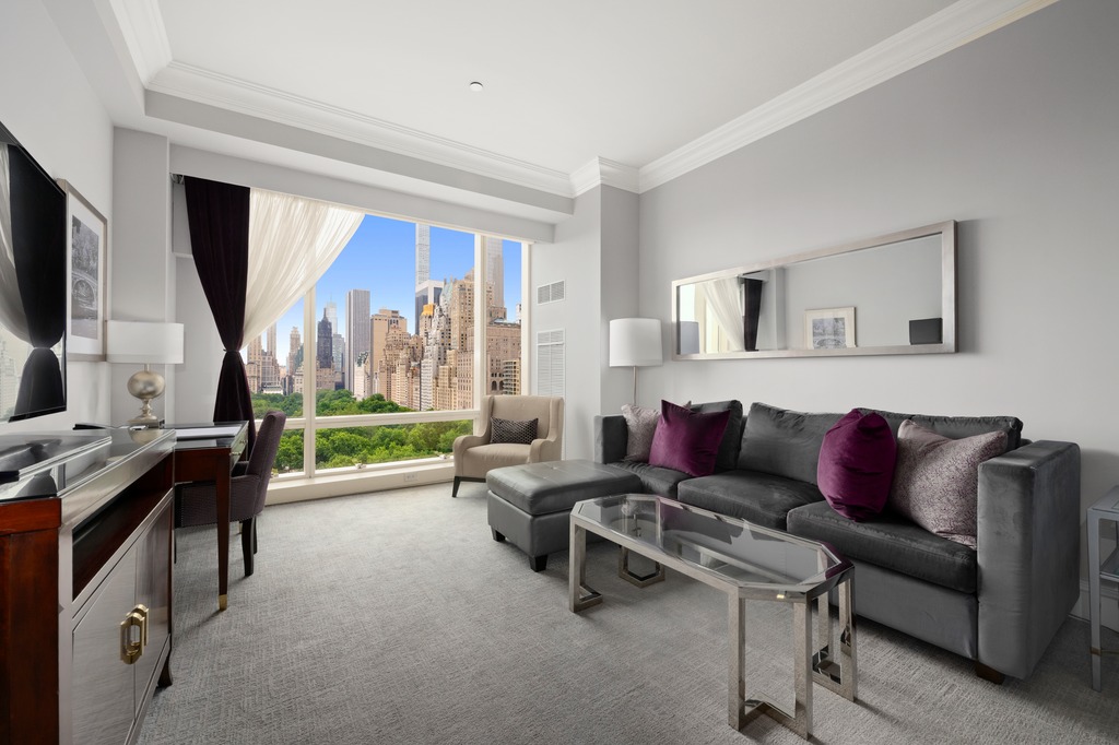 1 Central Park West, Unit 1506 Manhattan, NY 10023 - Photo 1 of 16 a living room with furniture and a flat screen tv