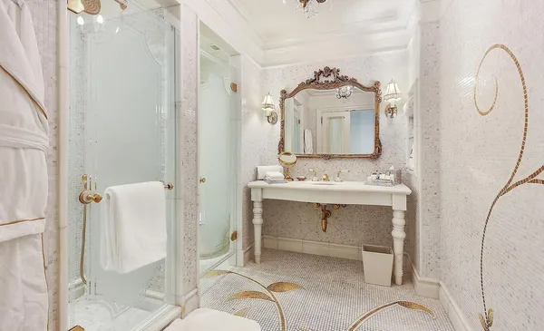 a bathroom with a sink mirror and a shower