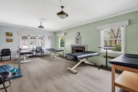 a view of a livingroom with workspace and a window