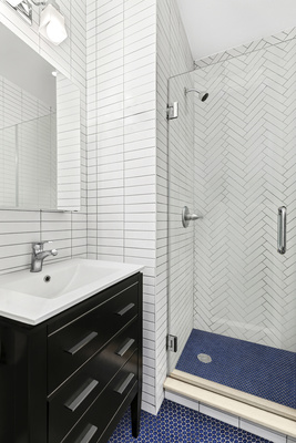 106 Bedford Avenue, Unit 3L Brooklyn, NY 11249 - Photo 5 of 7 a bathroom with a sink and a shower