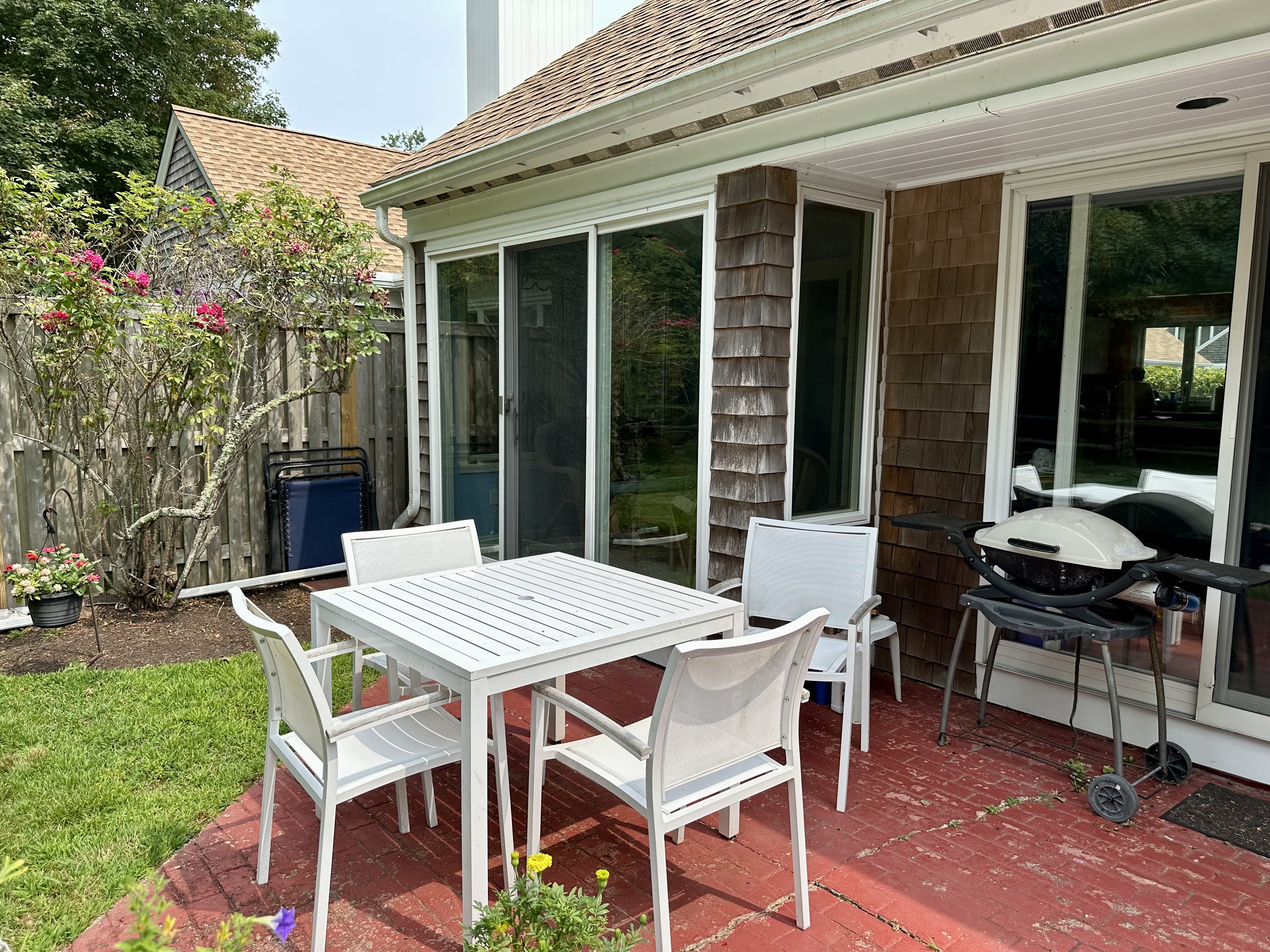 11 Juniper Circle Brewster, MA 02631 - Photo 17 of 29 a table and chairs in front of a house