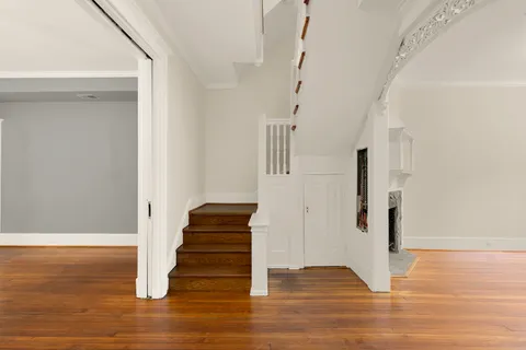 a view of entryway and hall with wooden floor