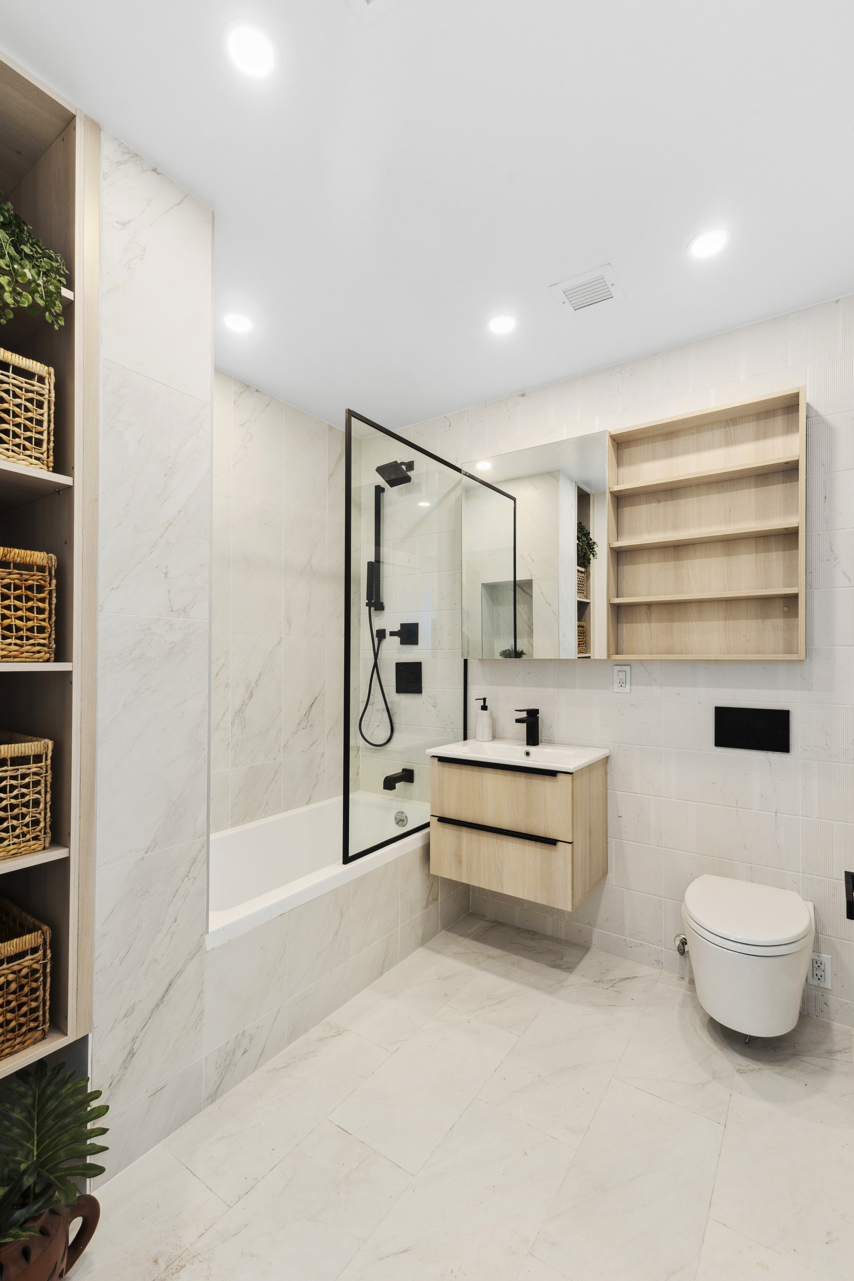 12-16 30th Avenue, Unit 401 Queens, NY 11102 - Photo 9 of 19 a bathroom with a tub and toilet