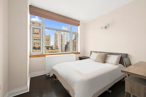 a bedroom with a bed and a window