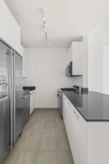 a large kitchen with a stove a sink and a refrigerator