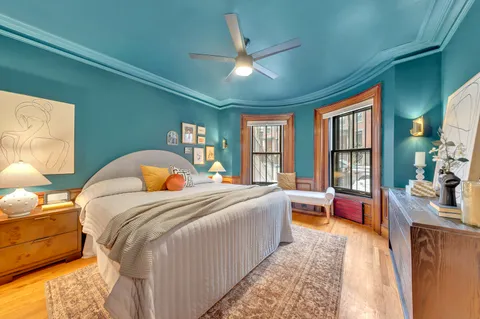 a bed room with a bed and a large window