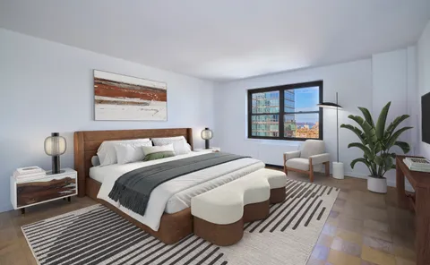 a bedroom with bed and a potted plant