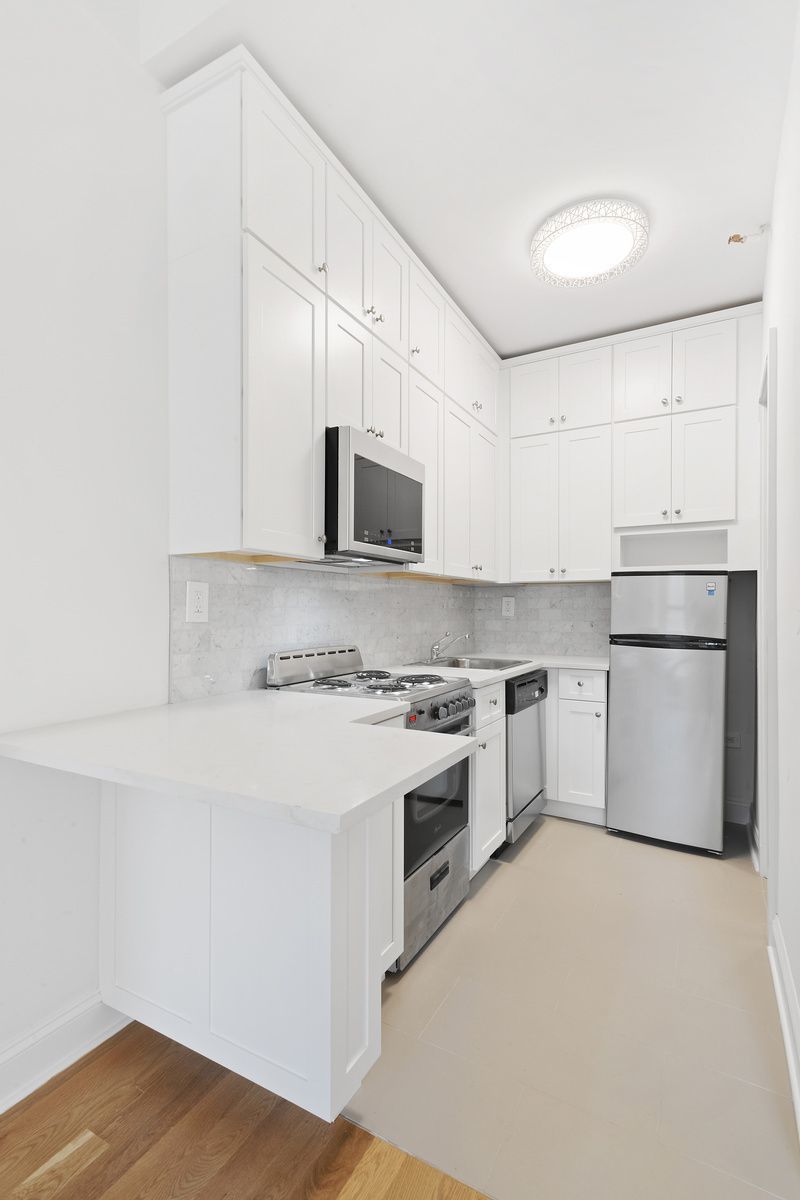 54 West 89th Street, Unit 3R Manhattan, NY 10024 - Photo 3 of 6 a kitchen with a stove a sink and a refrigerator
