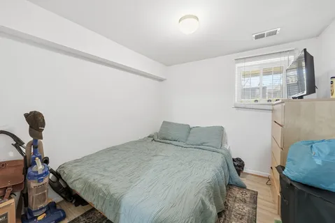 a bedroom with a bed and a dresser