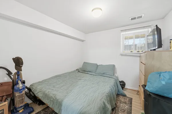 a bedroom with a bed and a dresser