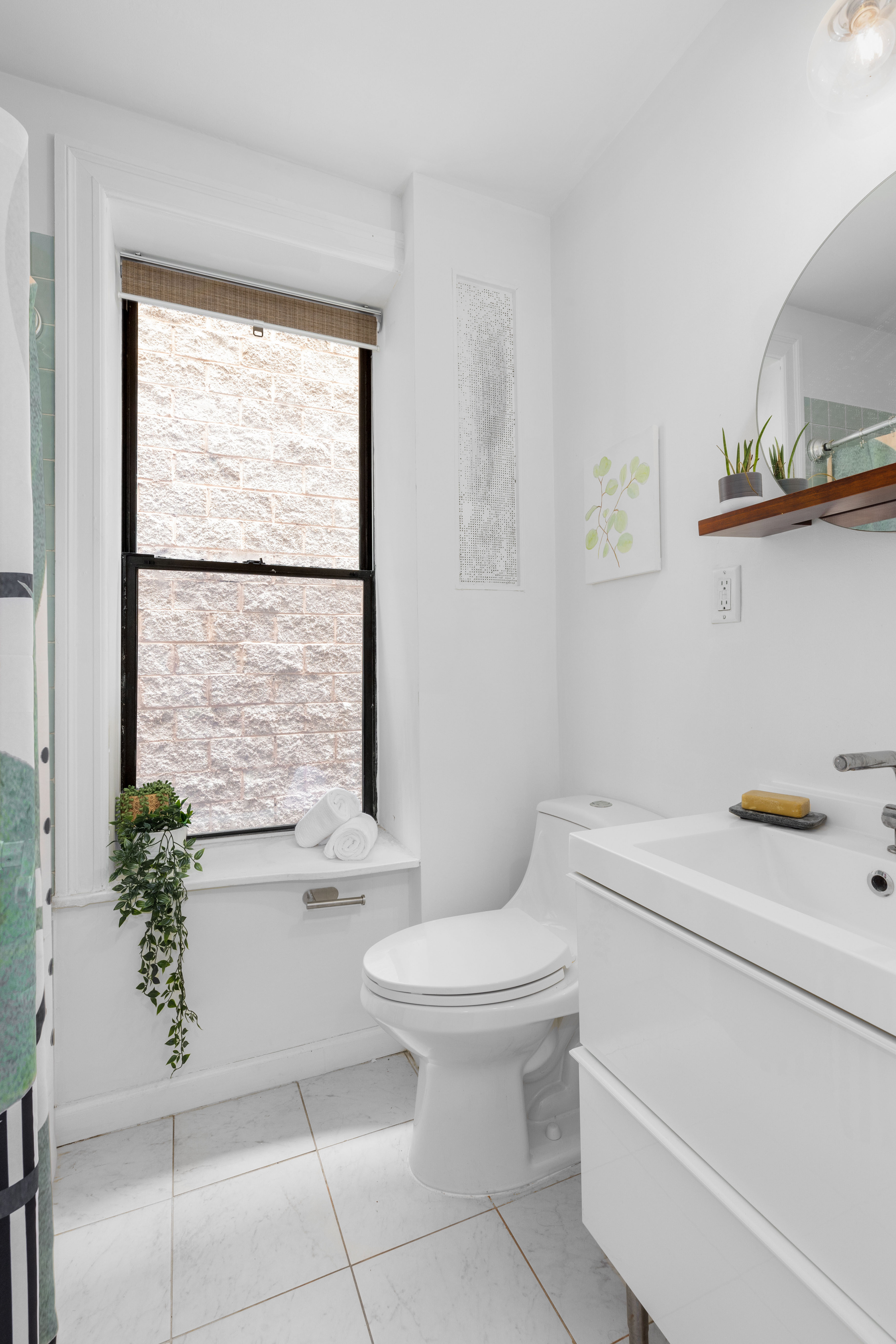 251 Pacific Street, Unit 8 Brooklyn, NY 11201 - Photo 5 of 9 a bathroom with a sink toilet and window
