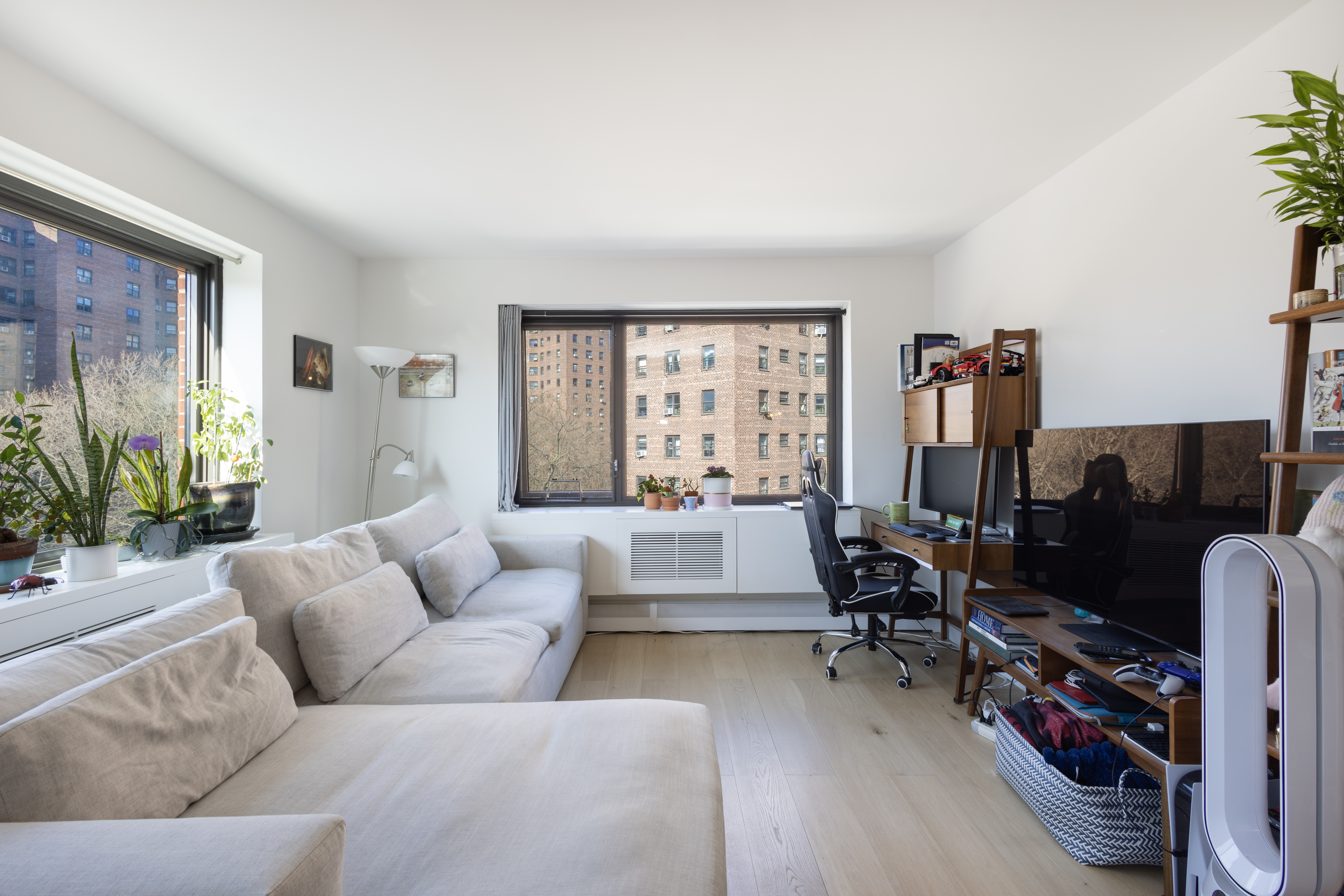 1330 5th Avenue, Unit 6C Manhattan, NY 10026 - Photo 4 of 16 a living room with furniture flat screen tv and a large window