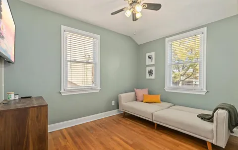 a bedroom with a bed wooden floor and window