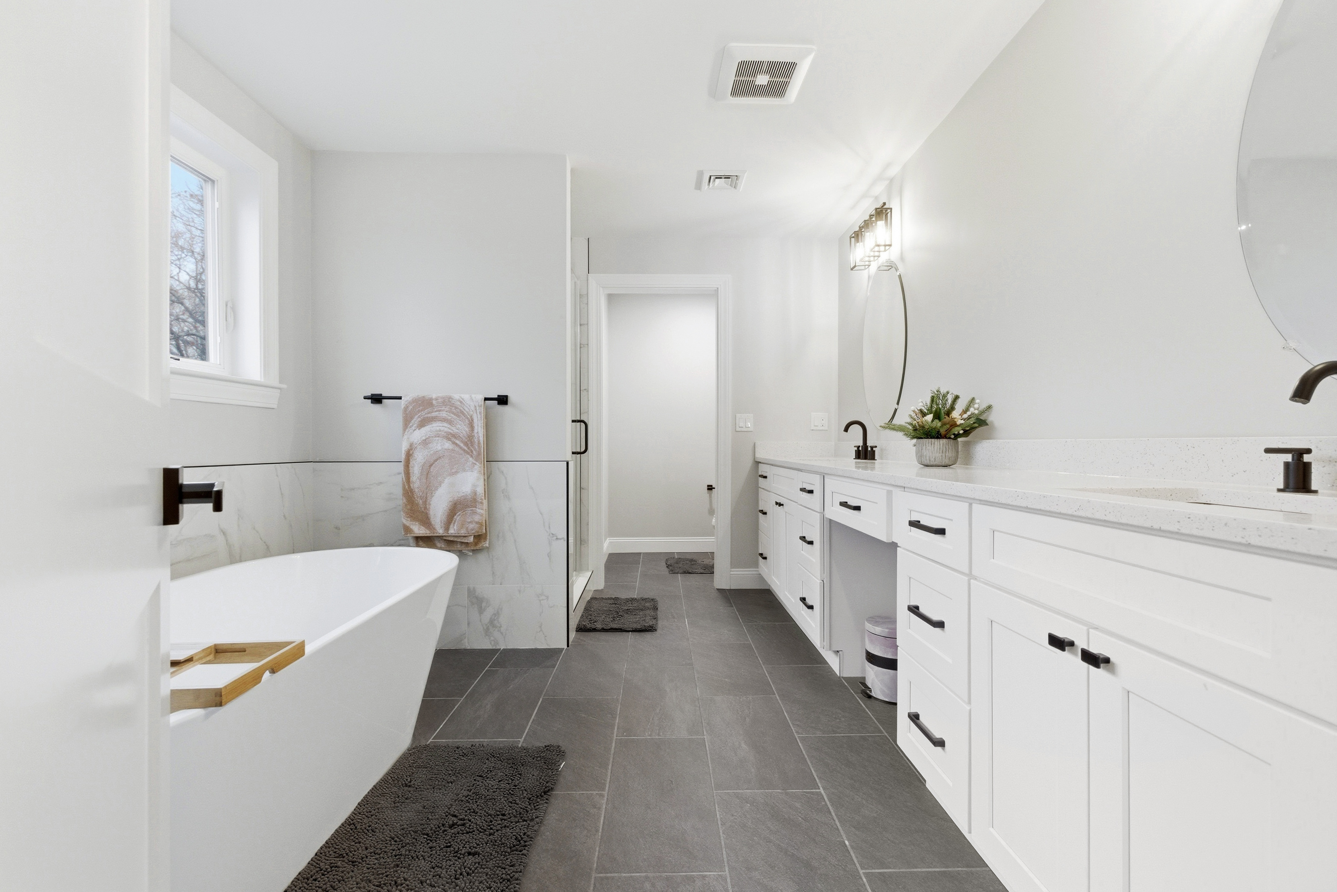 41 Peach Orchard Road Burlington, MA 01803 - Photo 8 of 15 a bathroom with a double vanity sink a mirror and a bathtub