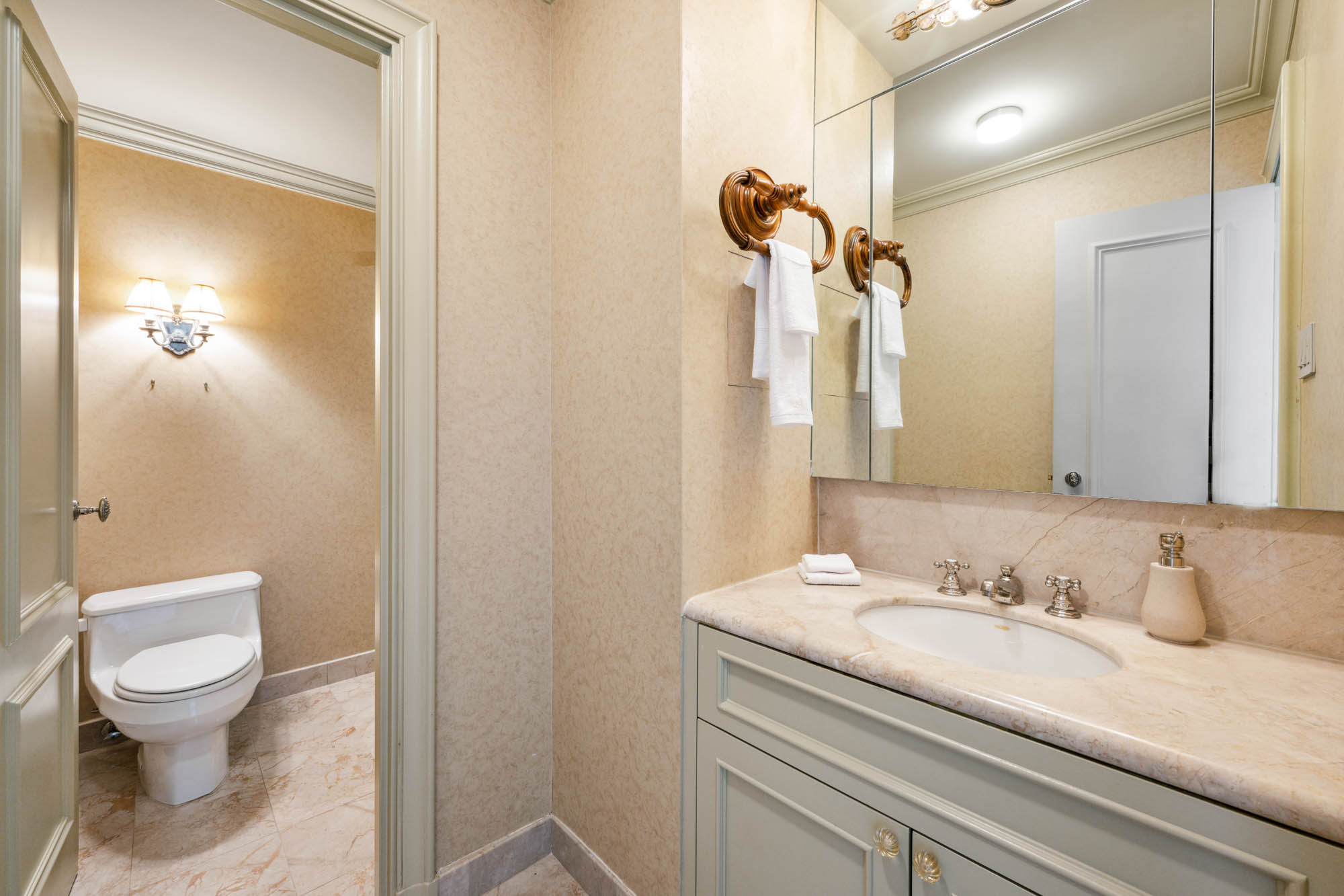 936 5th Avenue, Unit 10AB Manhattan, NY 10021 - Photo 30 of 37 a bathroom with a granite countertop sink toilet and shower
