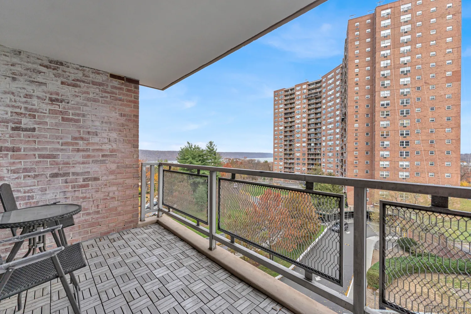 a view of balcony with wooden floor and fence