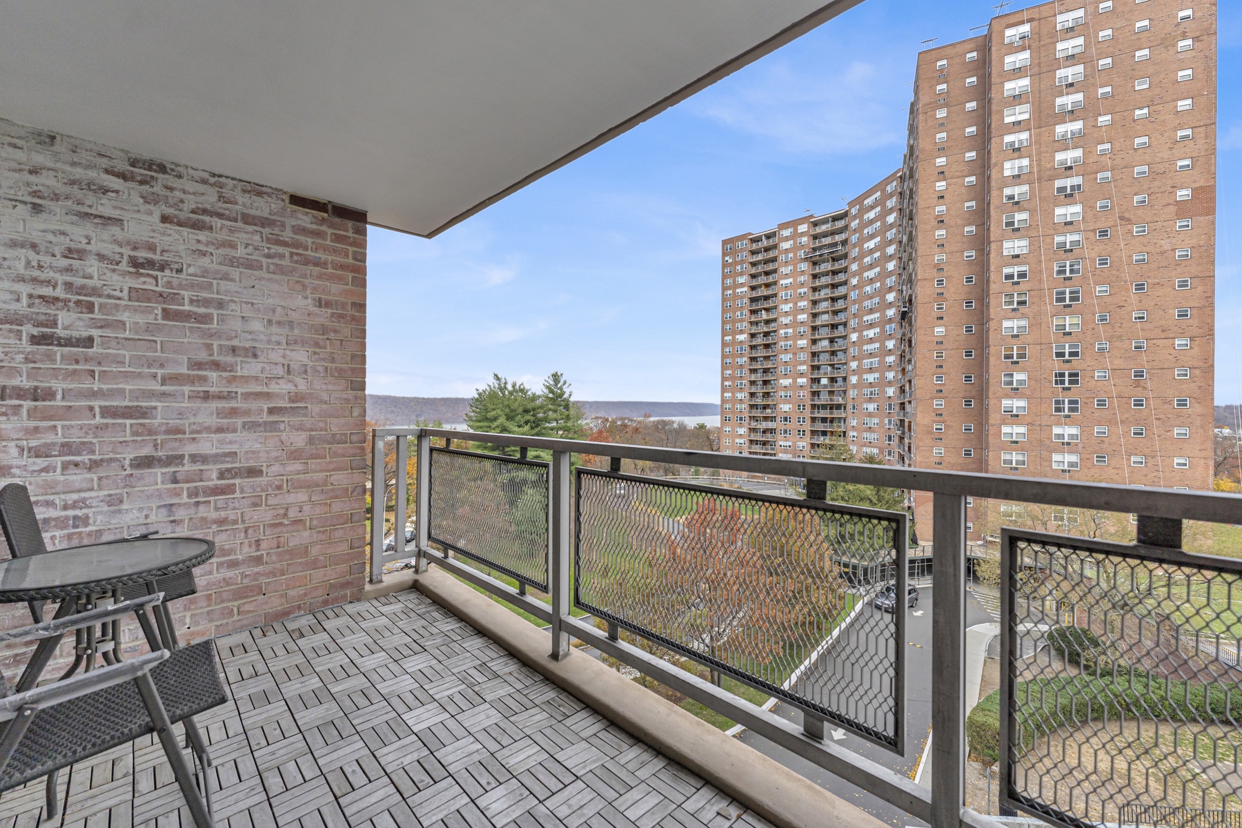 5800 Arlington Avenue, Unit 6V Bronx, NY 10471 - Photo 13 of 15 a view of balcony with wooden floor and fence