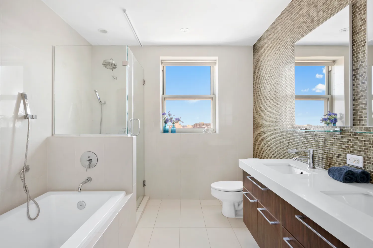a bathroom with a tub sink toilet and mirror