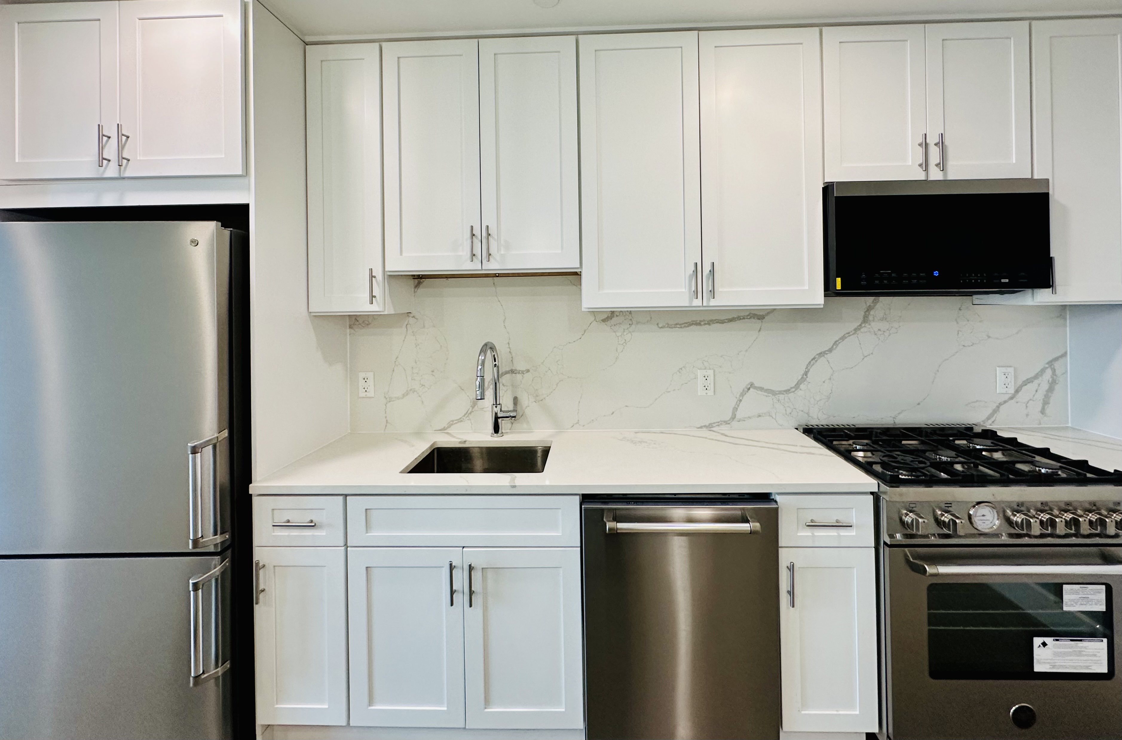 23 Bleecker Street, Unit 4E Brooklyn, NY 11221 - Photo 2 of 11 a kitchen with stainless steel appliances granite countertop a sink stove and refrigerator