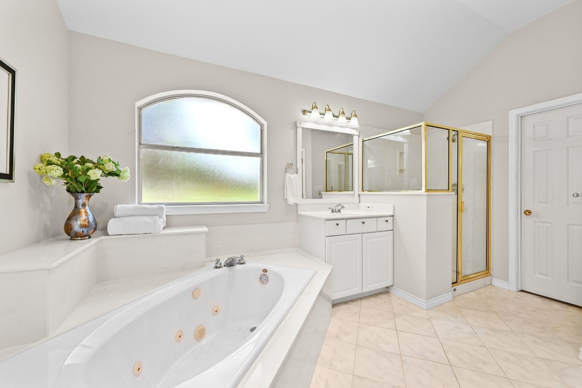 111 Trinity Street Cedar Creek, TX 78612 - Photo 20 of 38 a bathroom with a bathtub sink and mirror