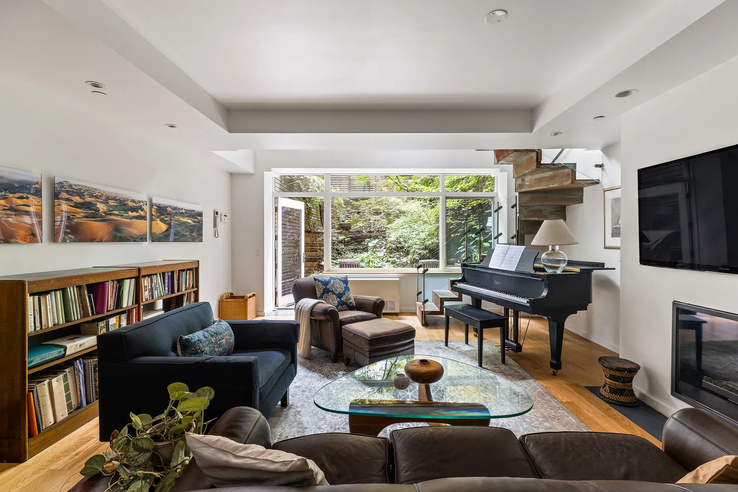 a living room with furniture fireplace and a large window