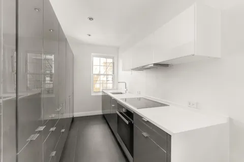 a kitchen with a sink and a refrigerator