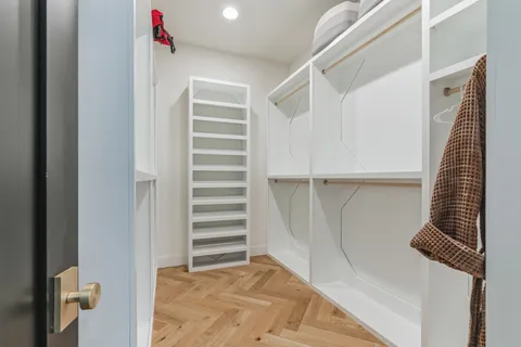 a view of walk in closet with empty racks