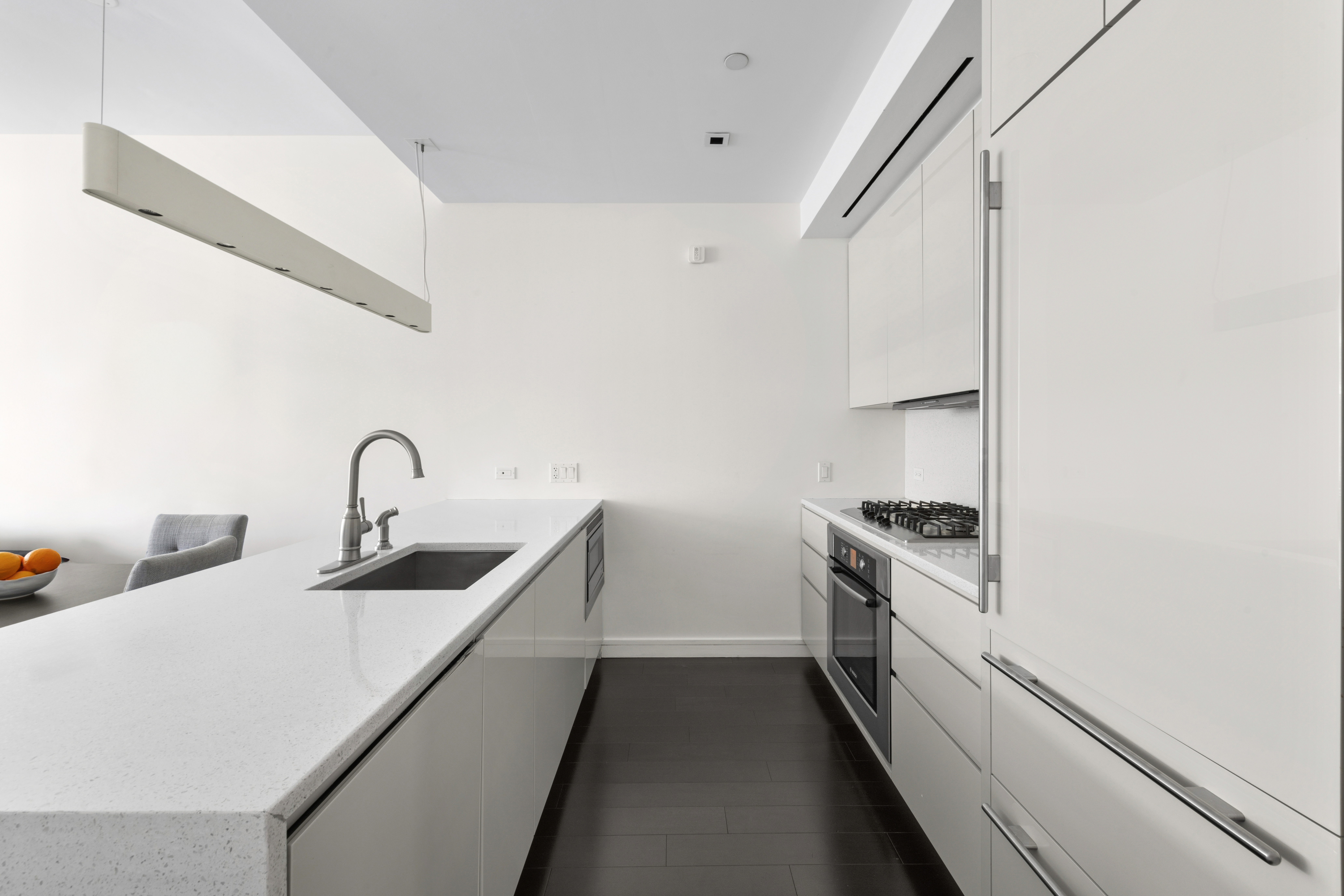 300 East 23rd Street, Unit 7A Manhattan, NY 10010 - Photo 3 of 15 a kitchen with stainless steel appliances and white cabinets