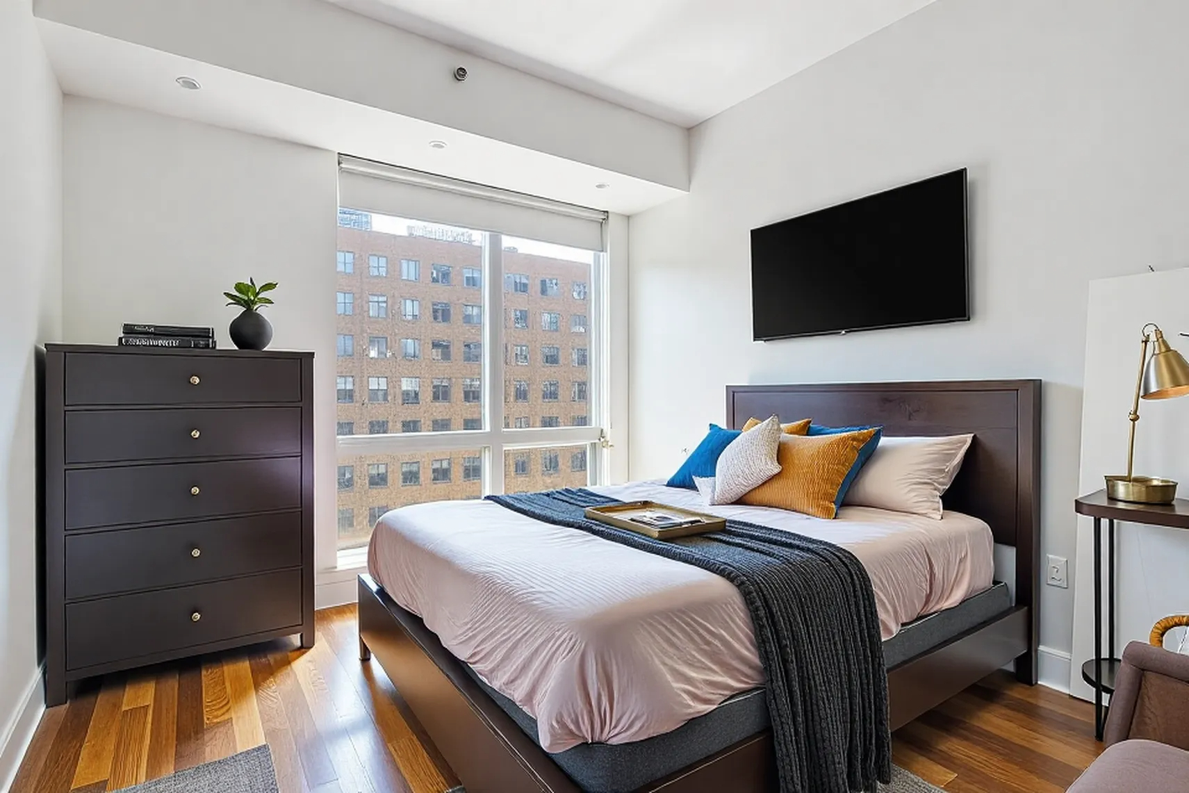 150 Myrtle Avenue, Unit 805 Brooklyn, NY 11201 - Photo 6 of 26 a bedroom with a bed and a flat tv screen on dresser