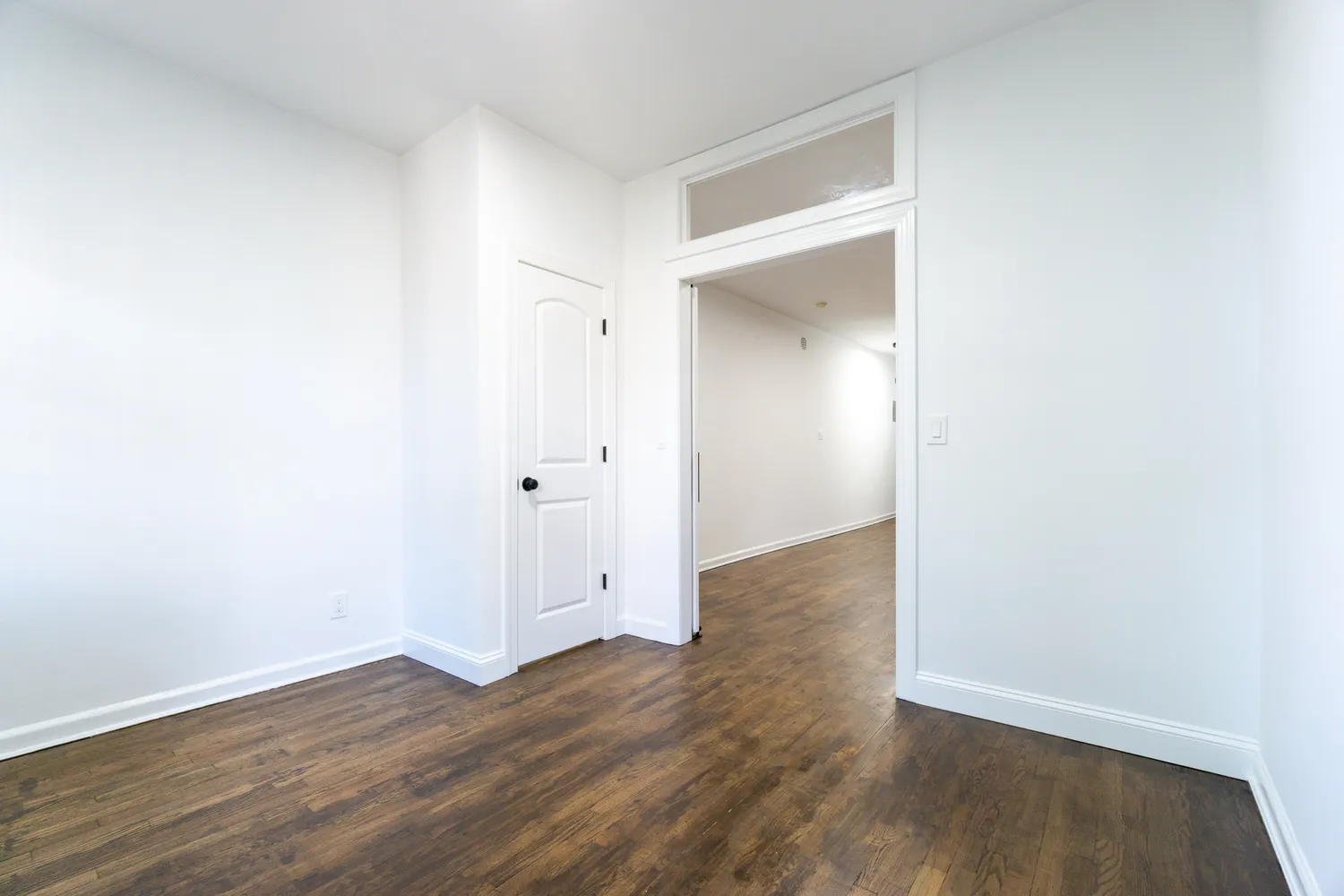 an empty room with wooden floor & closet