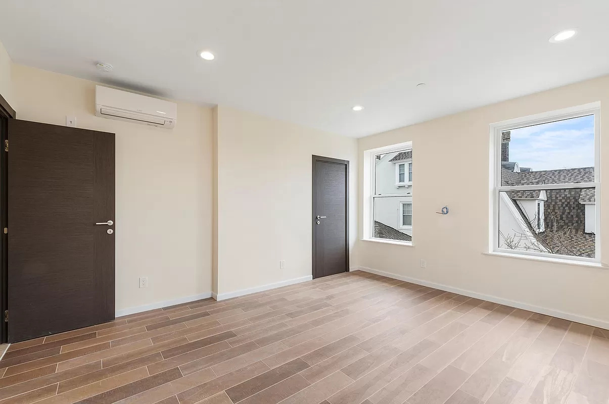 4015 Atlantic Avenue Brooklyn, NY 11224 - Photo 6 of 14 a view of an empty room with wooden floor and a window