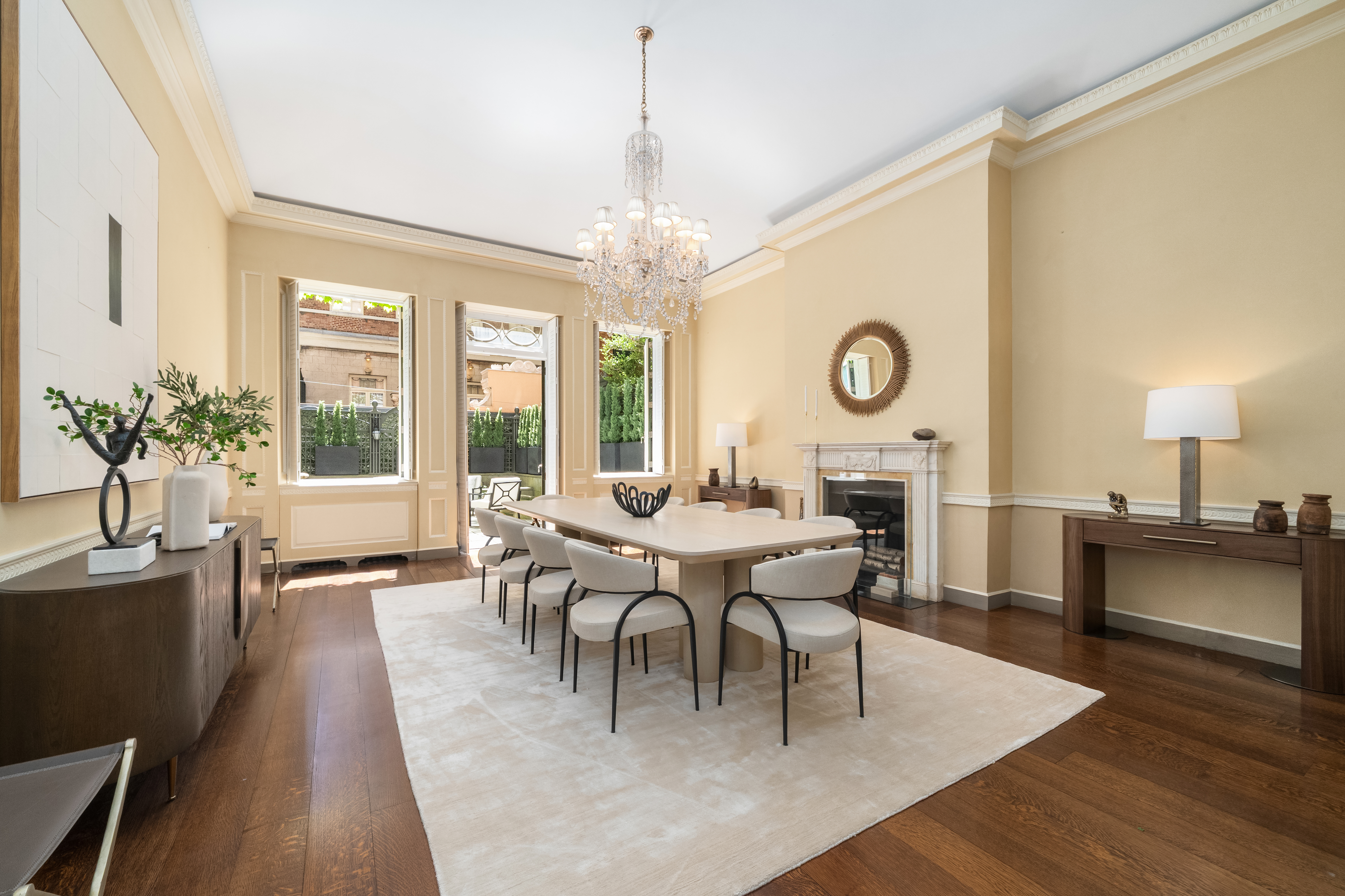 46 East 71st Street Manhattan, NY 10021 - Photo 5 of 27 a dining room with wooden floor a chandelier a wooden table and chairs